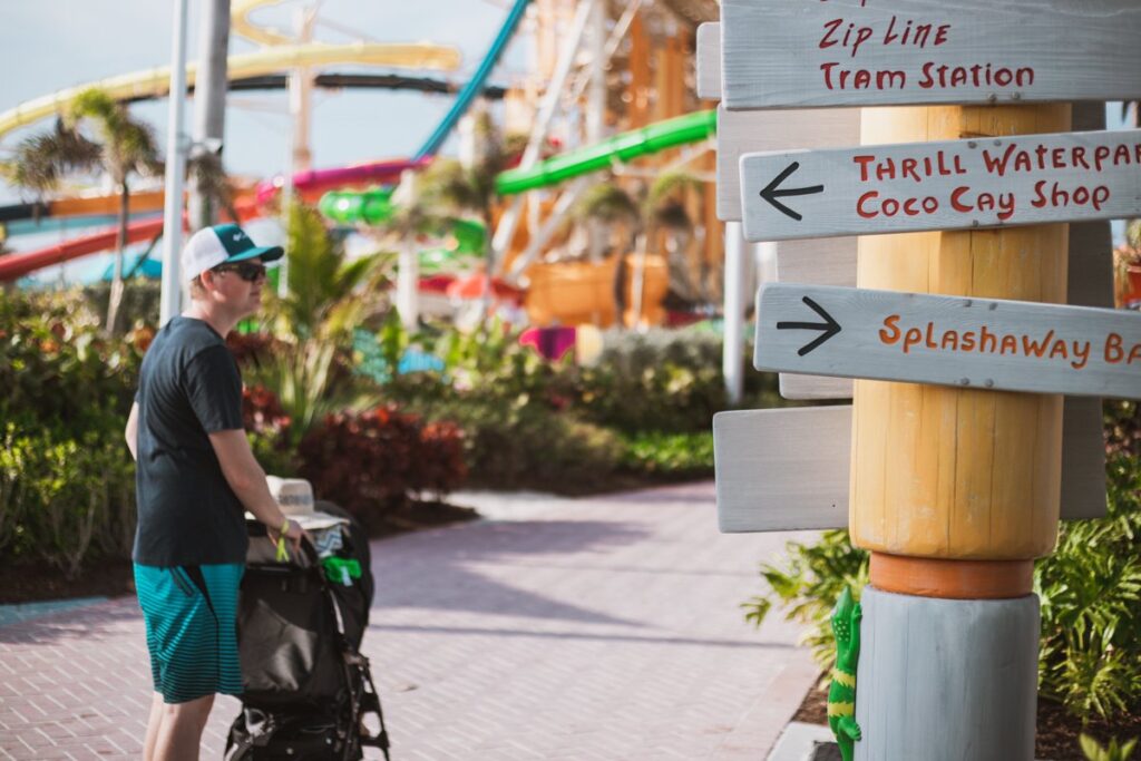 royal caribbean cococay with a toddler. dad pusing stroller in cococay
