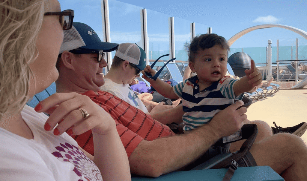 baby on a cruise with parents and grandparents on a family vacation.